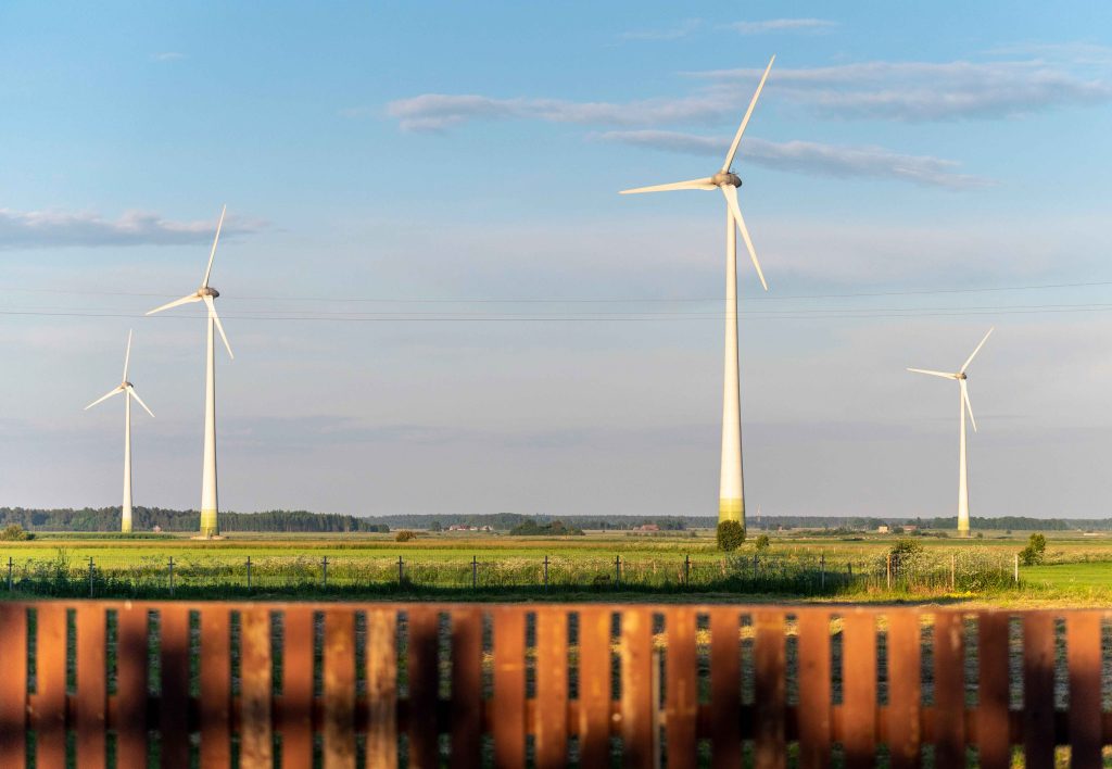 Wind turbines in open farmland, representing ISO 14001 environmental management
