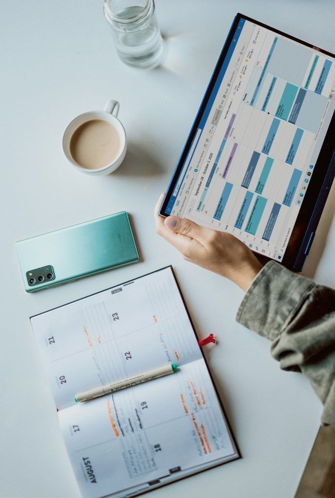 Weekly planner and a digital calendar on a desk, representing the ISO certification timeline